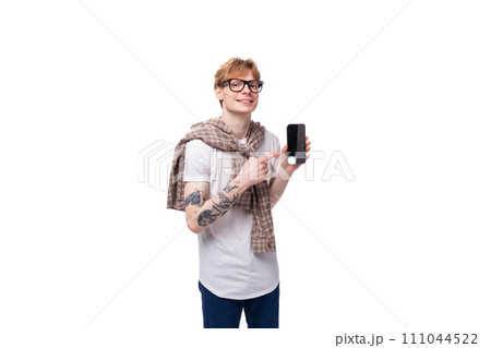 young friendly man with red hair holding smartphone with mockup young friendly man with red hair holding smartphone with mockup 111044522