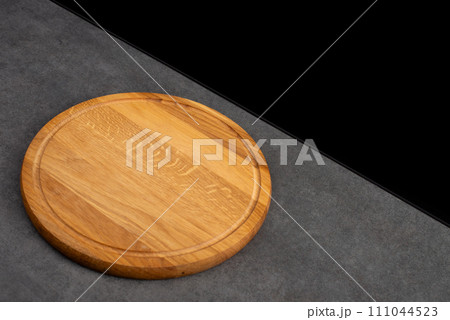 Black background with wooden pizza board Black background with wooden pizza board 111044523