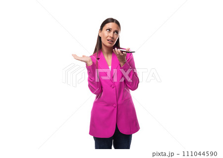 young well-groomed brunette successful boss woman dressed in a pink jacket speaks on the phone 111044590