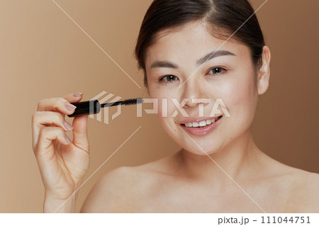 Portrait of young woman with mascara Portrait of young woman with mascara 111044751