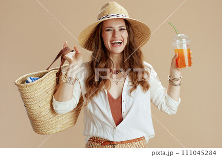 happy elegant woman in blouse and shorts on beige 111045284