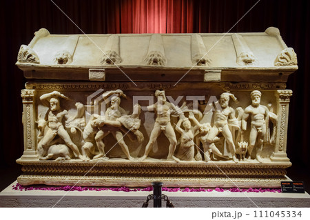 Marble sarcophagus with the image of antique figures of naked people, Antique scenes on the bas-reliefs of the sarcophagus. 111045334