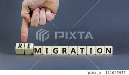 Migration or remigration symbol. Concept word Migration Remigration on beautiful wooden cubes. Beautiful grey background. Businessman hand. Business migration or remigration concept. Copy space. 111045955