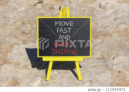 Move fast and break things symbol. Concept words Move fast and break things on beautiful blackboard. Beautiful stone beach background. Business, move fast and break things concept. Copy space. Move fast and break things symbol. Concept words Move fast and break things on beautiful blackboard. Beautiful stone beach background. Business, move fast and break things concept. Copy space. 111045972