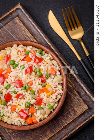 Delicious white boiled rice with vegetables, sweet peppers, carrots, peas, salt and spices 111046167