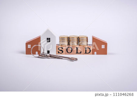 The inscription Sold made of wooden cubes on a plain background 111046268