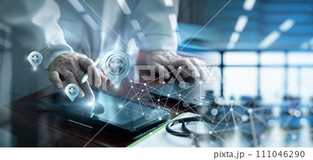 A doctor using a tablet computer to search for a location. 111046290