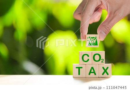 Carbon tax concept. Environmental and social responsibility business. Taxation for nature pollution. Wooden cubes with CO2 TAX word and factory icon. Carbon pricing and credits, Climate finance, Carbon tax concept. Environmental and social responsibility business. Taxation for nature pollution. Wooden cubes with CO2 TAX word and factory icon. Carbon pricing and credits, Climate finance, 111047445