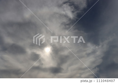 The sun is hidden behind thick clouds. The sun is hidden behind thick clouds. 111048407