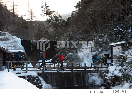 長野県茅野市の厳冬期の東天狗岳の渋ノ湯ルート上の橋を渡る登山者の冬景色 長野県茅野市の厳冬期の東天狗岳の渋ノ湯ルート上の橋を渡る登山者の冬景色 111049913