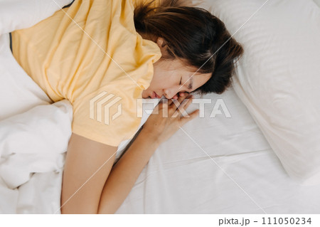 Asian woman sleeping deeply as she tired and sick. 111050234