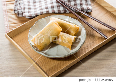 Fried Spring rolls on plate with chopsticks and spoon - Asian food style 111050405
