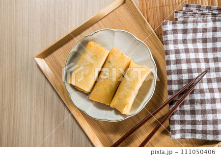Fried Spring rolls on plate with chopsticks and spoon - Asian food style Fried Spring rolls on plate with chopsticks and spoon - Asian food style 111050406