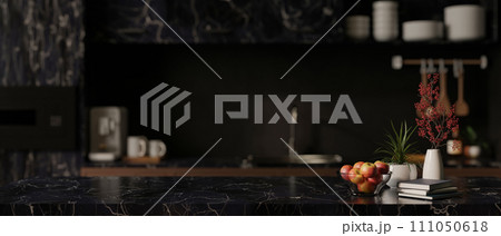 Empty copy space on a luxury black marble table in a modern, black kitchen with kitchen appliances. 111050618