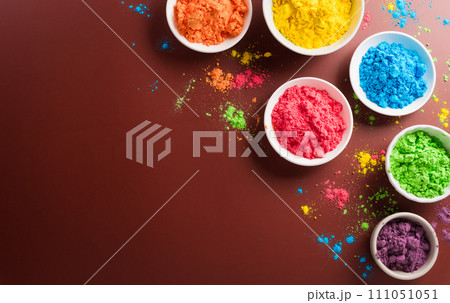 Happy Holi decoration, the indian festival.Top view of colorful holi powder on dark background. Happy Holi decoration, the indian festival.Top view of colorful holi powder on dark background. 111051051