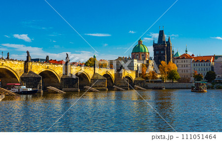 View of Prague, Charles bridge and the Vltava river with tourist boats floating 111051464