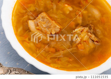 Sour cabbage soup served in bowl 111051535