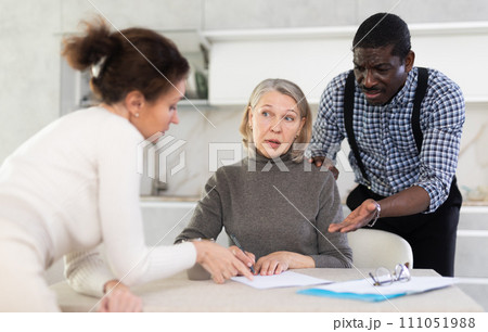 Elderly woman writes a will. Relatives argue and indicate what to write in will 111051988
