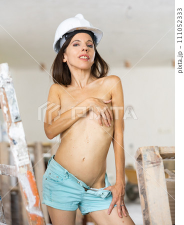 Topless young adult woman posing near stepladder 111052333