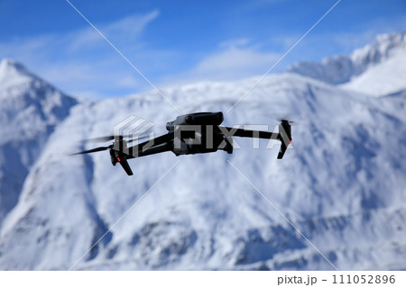 Flying drone in high altitude mountains Flying drone in high altitude mountains 111052896