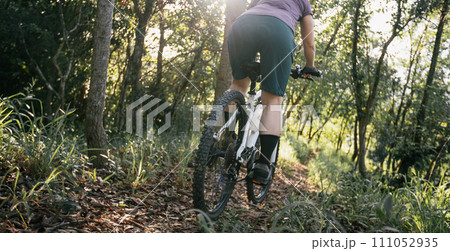 Mountain biking on spring forest trail Mountain biking on spring forest trail 111052935