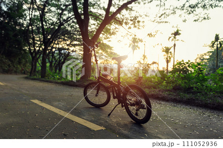 A folding bike on sunset road A folding bike on sunset road 111052936