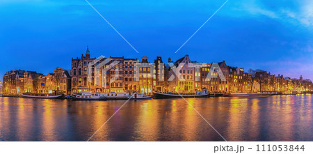 Amsterdam Netherlands, night panorama city skyline of Dutch house at canal waterfront Amsterdam Netherlands, night panorama city skyline of Dutch house at canal waterfront 111053844