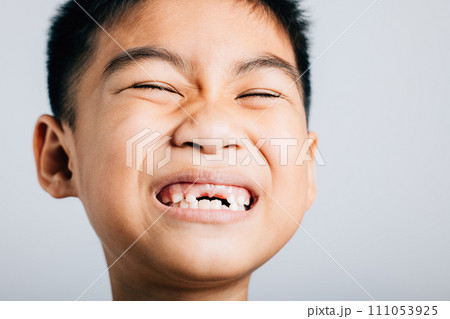 Smiling schoolboy tooth lost gap shows. Child isolated portrait on white. Joyful dental growth development. Children show teeth new gap, dentist problems. little boy no tooth Smiling schoolboy tooth lost gap shows. Child isolated portrait on white. Joyful dental growth development. Children show teeth new gap, dentist problems. little boy no tooth 111053925