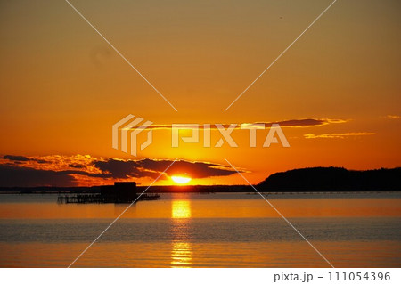 霞ヶ浦・初春の夕陽 網いけすと輝く水面の風景 霞ヶ浦・初春の夕陽 網いけすと輝く水面の風景 111054396