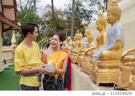 On Songkran Day, young Thai people wear Thai costumes to bathe Buddha statues and play on Songkran Day. 111054929