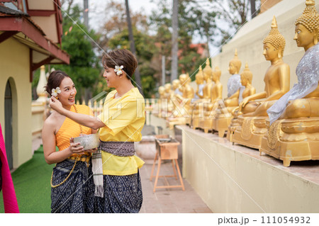 On Songkran Day, young Thai people wear Thai costumes to bathe Buddha statues and play on Songkran Day. On Songkran Day, young Thai people wear Thai costumes to bathe Buddha statues and play on Songkran Day. 111054932