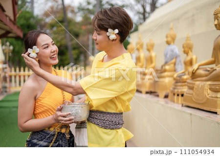 On Songkran Day, young Thai people wear Thai costumes to bathe Buddha statues and play on Songkran Day. On Songkran Day, young Thai people wear Thai costumes to bathe Buddha statues and play on Songkran Day. 111054934