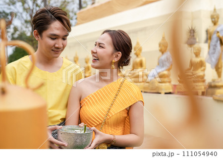 On Songkran Day, young Thai people wear Thai costumes to bathe Buddha statues and play on Songkran Day. On Songkran Day, young Thai people wear Thai costumes to bathe Buddha statues and play on Songkran Day. 111054940