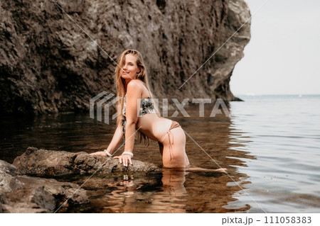 Woman travel sea. Happy tourist enjoy taking picture outdoors for memories. Woman traveler swim in the sea bay with mountains, sharing travel adventure journey 111058383