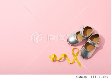 Silver children's shoes with a yellow ribbon Silver children's shoes with a yellow ribbon 111059465
