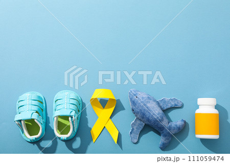 Blue children's shoes with a yellow ribbon and medicine Blue children's shoes with a yellow ribbon and medicine 111059474