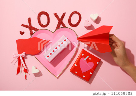 Flat lay plate in the shape of a heart on a pink background. 111059502