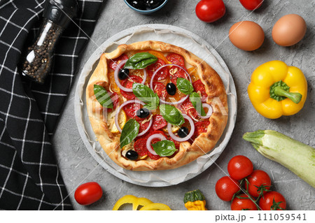 Freshly baked vegetable galette with fresh vegetables 111059541