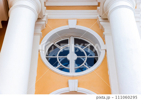Classic architecture details, round window with white frame 111060295