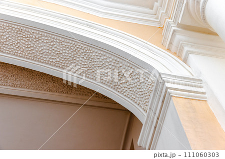 Classical portico details. White arched doorway Classical portico details. White arched doorway 111060303