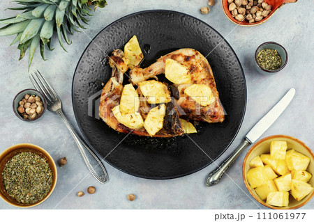 Barbecued chicken drumsticks and pineapple. 111061977