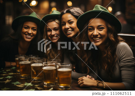 A group of young women in green hats relaxing in a beer bar. A group of young women in green hats relaxing in a beer bar. 111062511