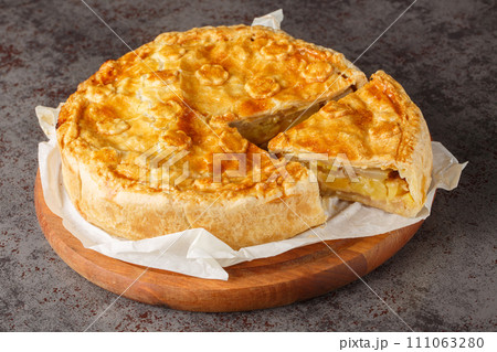 Switzerland food Walliser Cholera cake with potato, leek , apple, cheese closeup on the wooden board. Horizontal Switzerland food Walliser Cholera cake with potato, leek , apple, cheese closeup on the wooden board. Horizontal 111063280