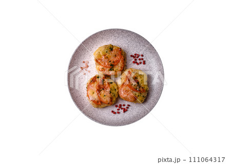 Delicious baked fish fillet with cheese, tomatoes, salt, spices and herbs 111064317