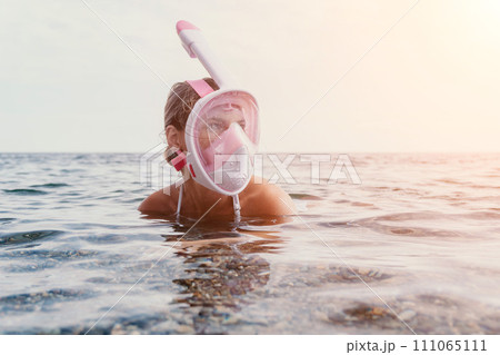 Young happy woman in white bikini and wearing pink mask gets ready for sea snorkeling. Positive smiling woman relaxing and enjoying water activities with family summer travel holidays vacation on sea. Young happy woman in white bikini and wearing pink mask gets ready for sea snorkeling. Positive smiling woman relaxing and enjoying water activities with family summer travel holidays vacation on sea. 111065111