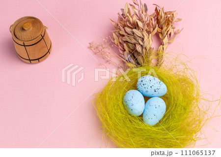 Nest with colored Easter eggs on the pink background. Nest with colored Easter eggs on the pink background. 111065137
