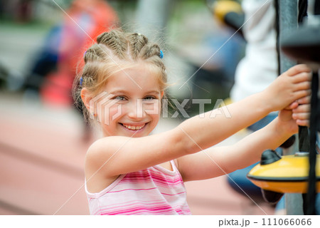 Portrait of Happy smiling little girl playing at the playground and climb the ropes outdoor Portrait of Happy smiling little girl playing at the playground and climb the ropes outdoor 111066066