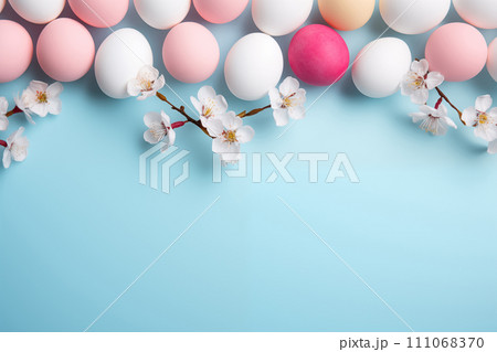 Top view colorful easter egg with cherry blossom on blue background, copy space, generative Al. 111068370