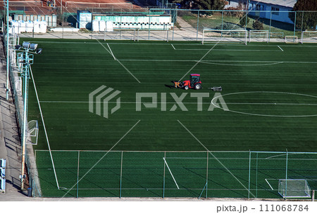 Top view on a tractor cares for the football field Top view on a tractor cares for the football field 111068784