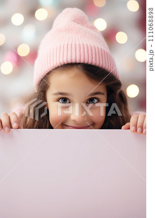 AI-generated content. Girl peeking out from behind a pink background with a defocused background. Cozy atmosphere. Winter promotional banner mockup with copy space. 111068898
